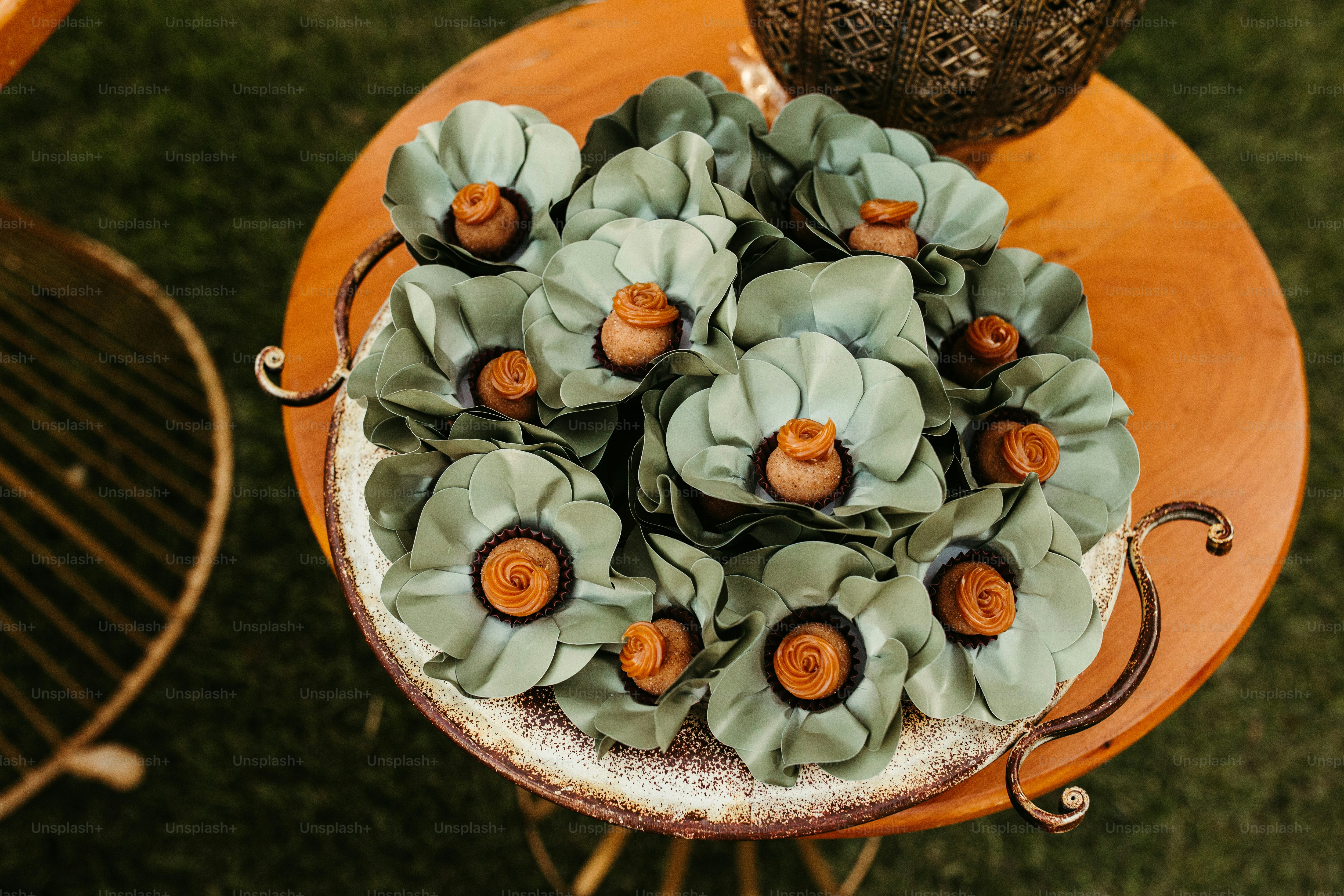 a bunch of flowers sitting on top of a wooden table