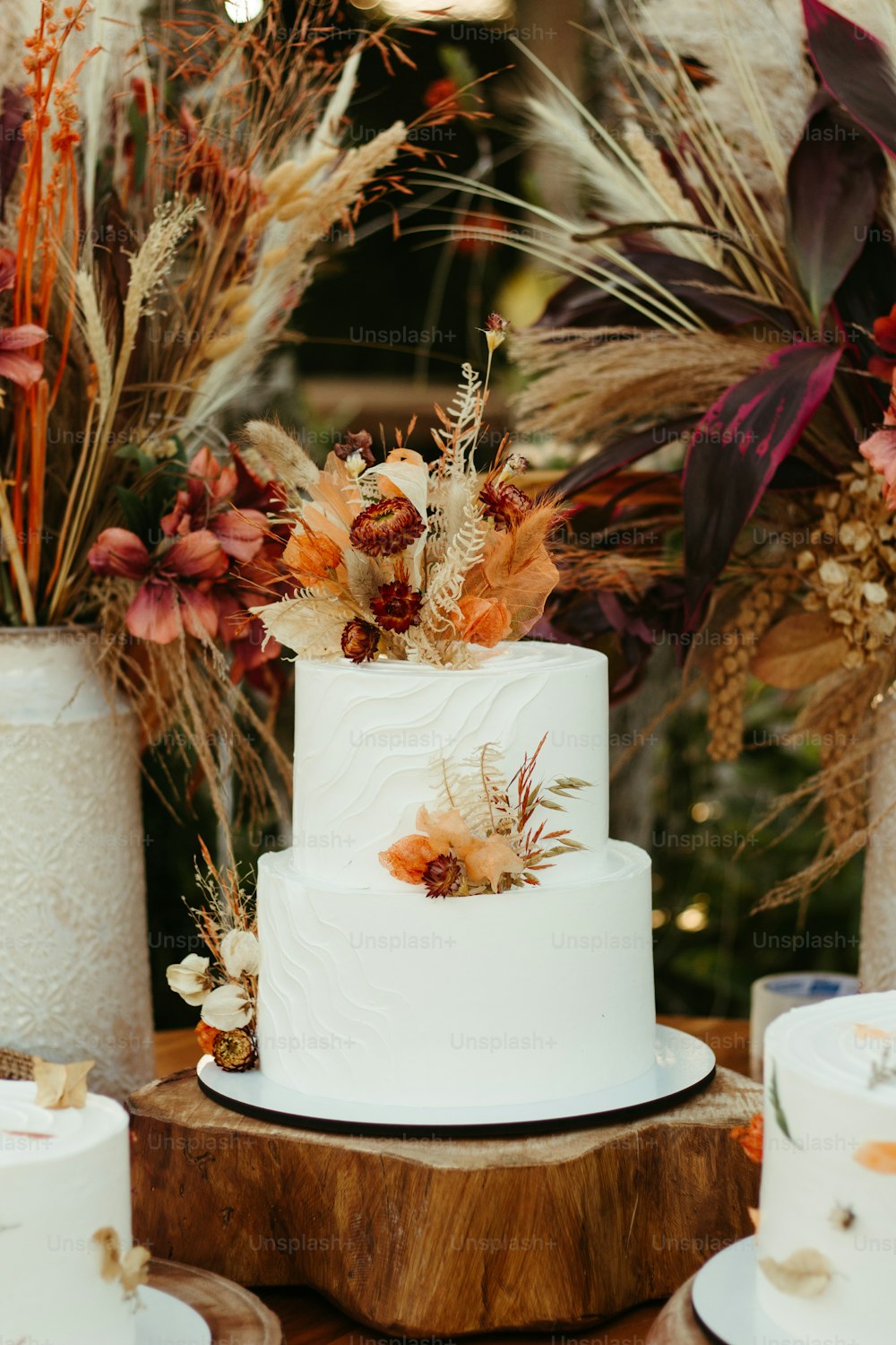 a white wedding cake sitting on top of a wooden table