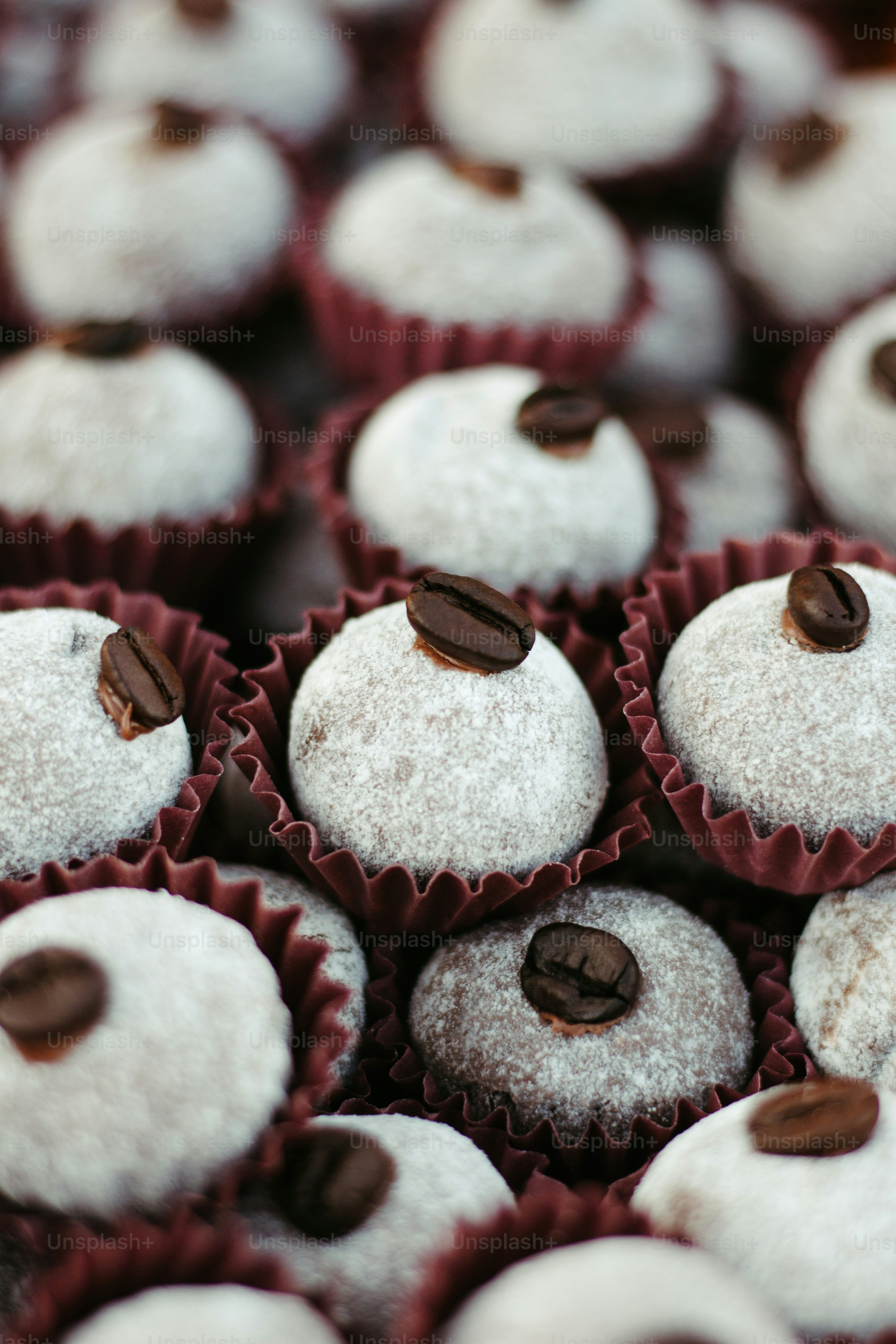a close up of a tray of cupcakes covered in powdered sugar