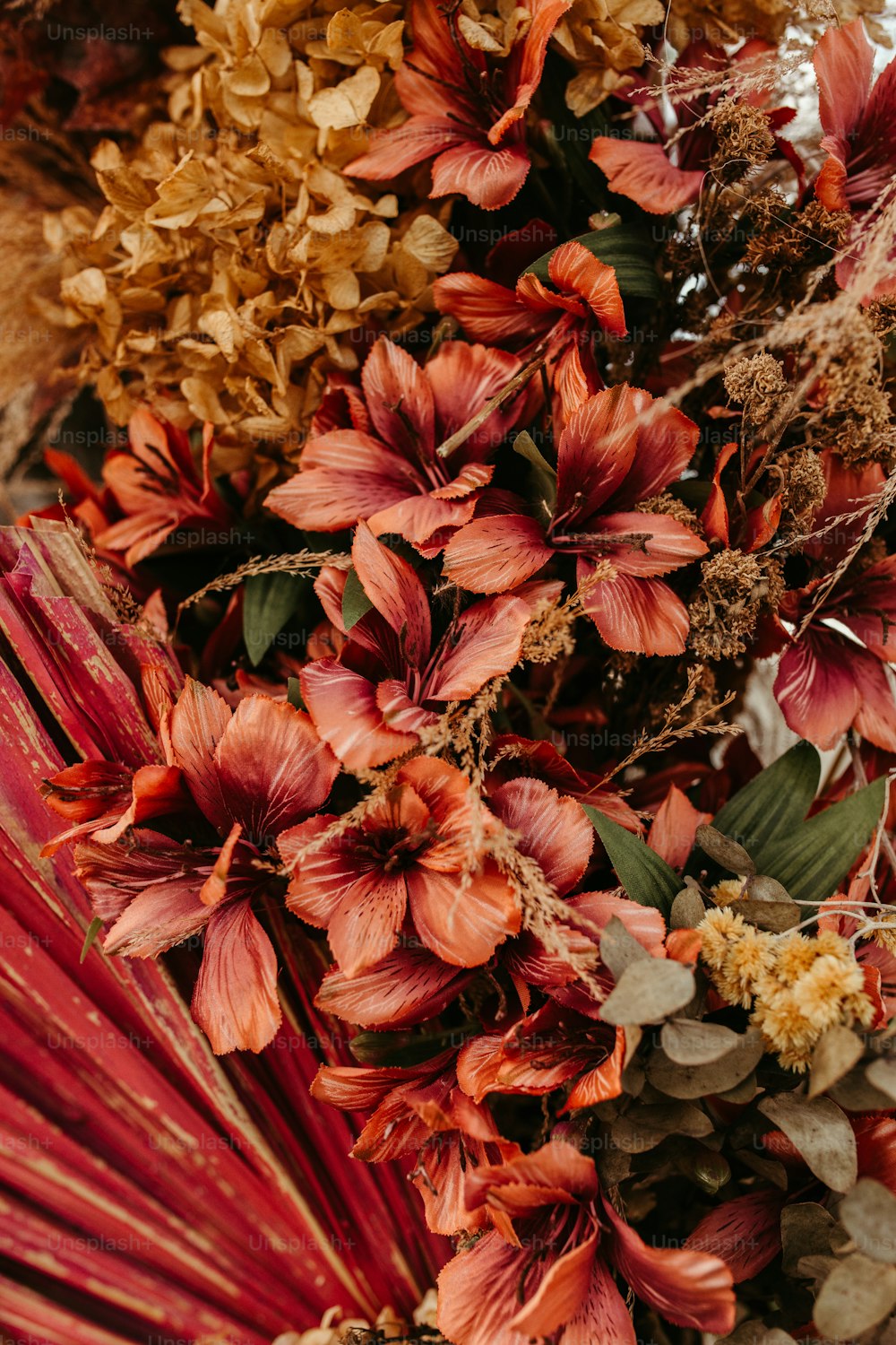 a bunch of flowers that are next to a red umbrella