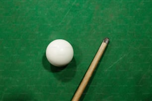 a pool table with a pool cue and ball