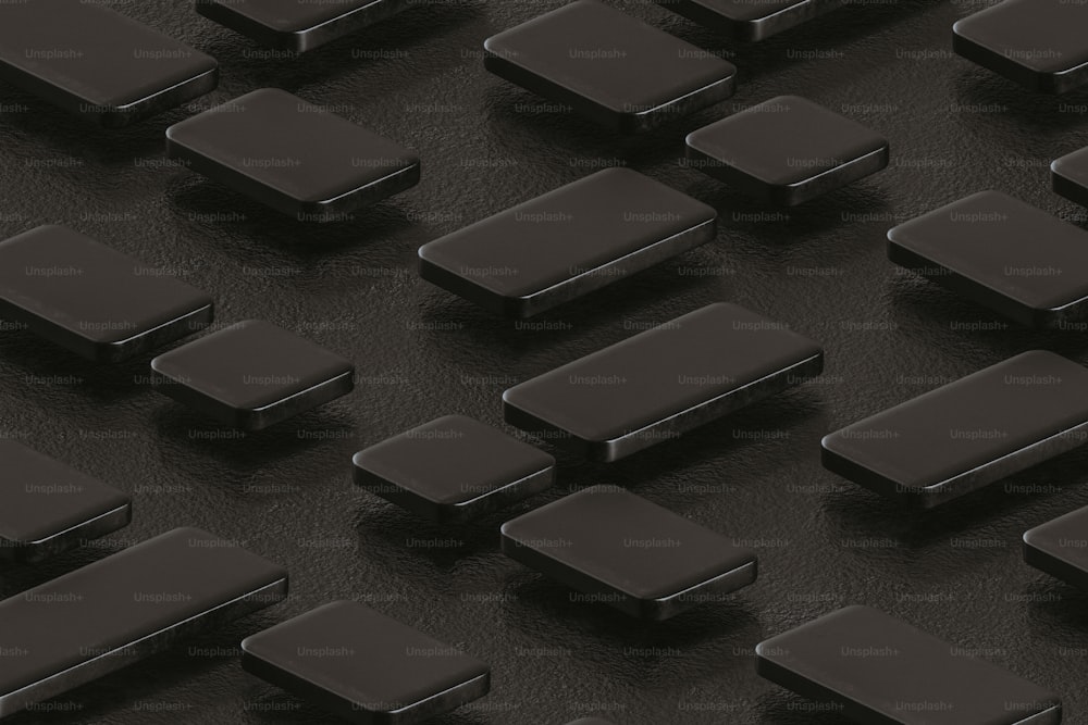 a group of black square objects on a black surface
