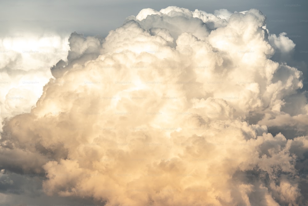 a plane flying in front of a large cloud