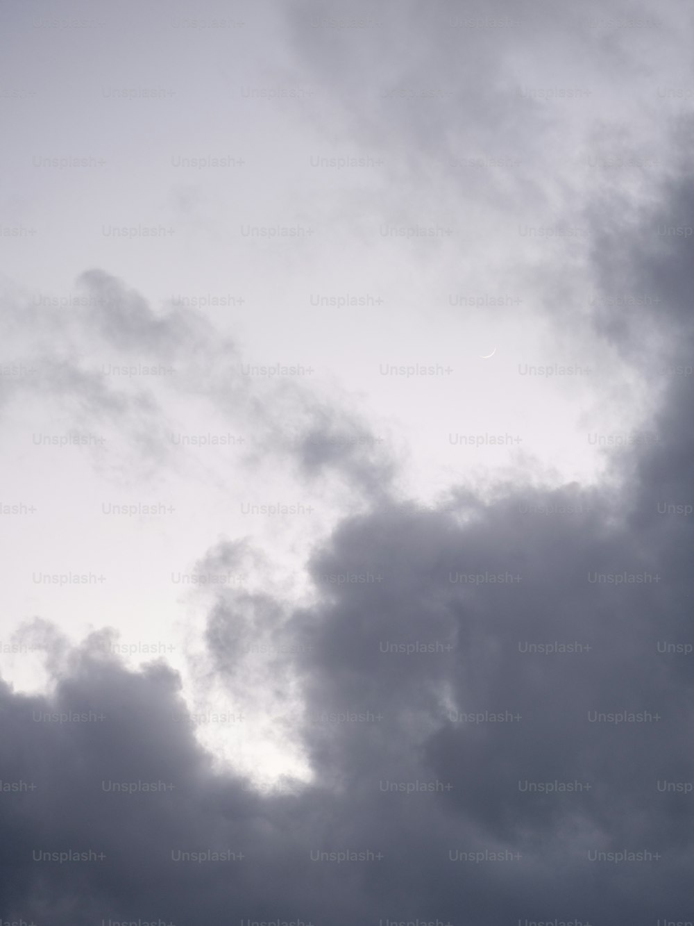 Un avión volando a través de un cielo nublado en un día nublado