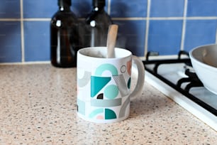 a mug with a spoon in it sitting on a counter