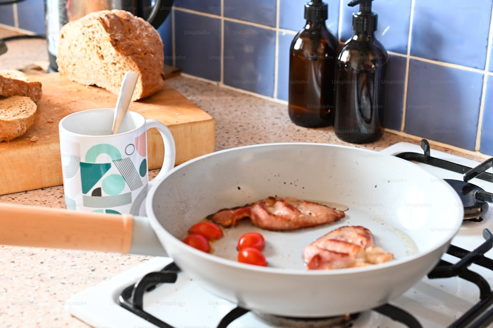 a frying pan filled with food on top of a stove