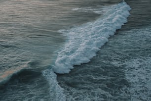 a wave is coming in to the shore of the ocean