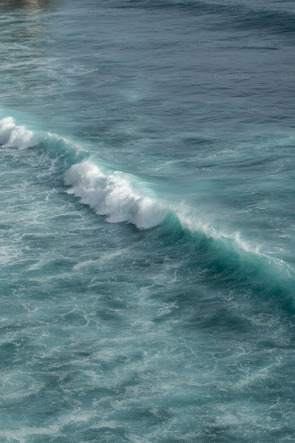 a person riding a surfboard on a wave in the ocean