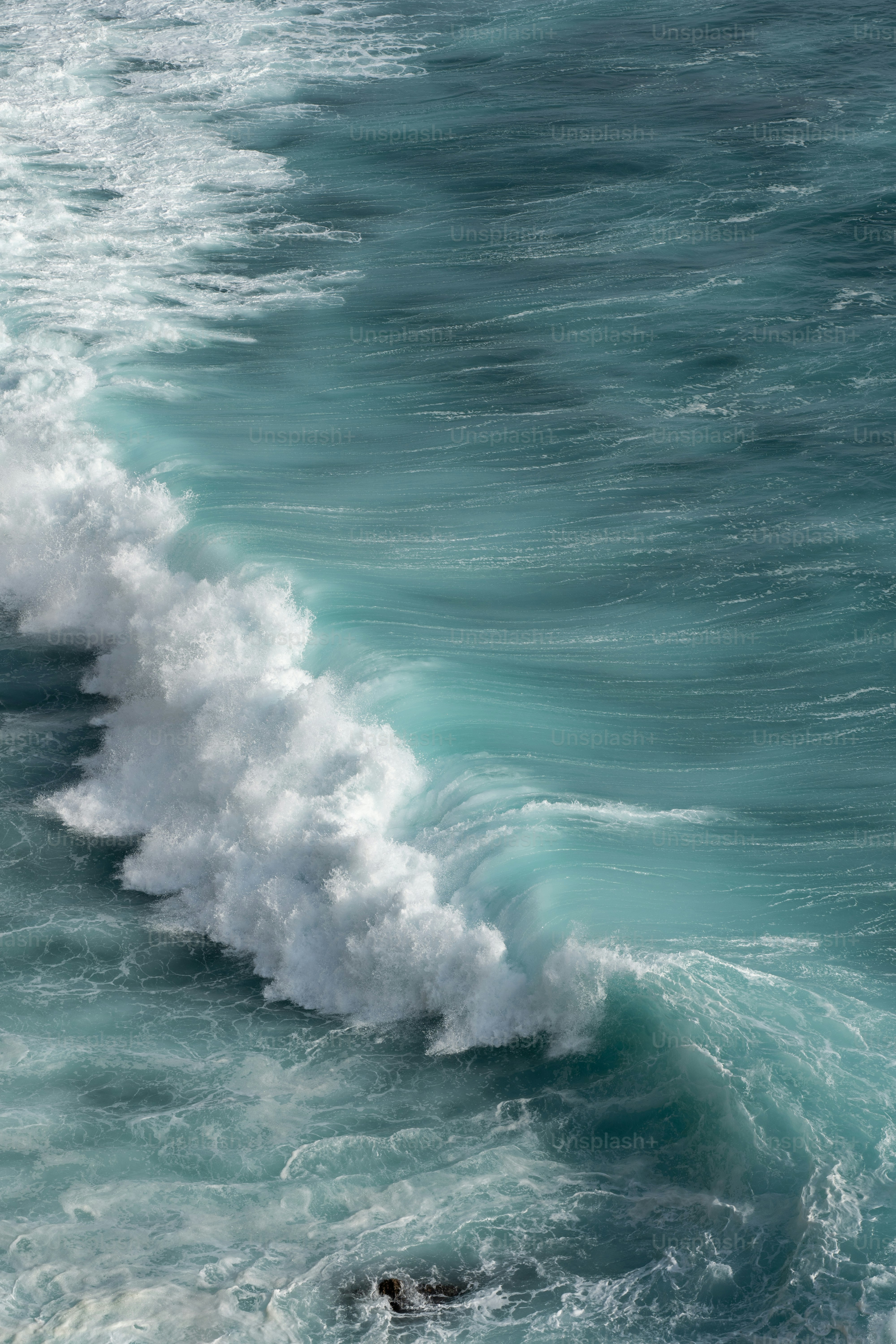 a person riding a surfboard on a wave in the ocean