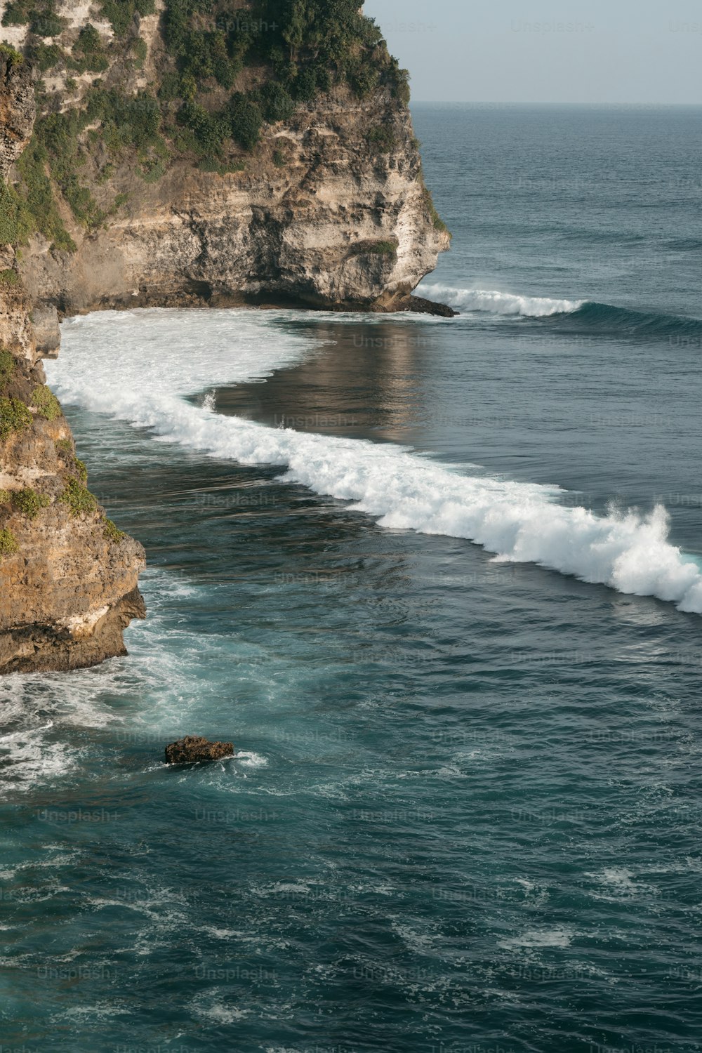 a large body of water next to a cliff