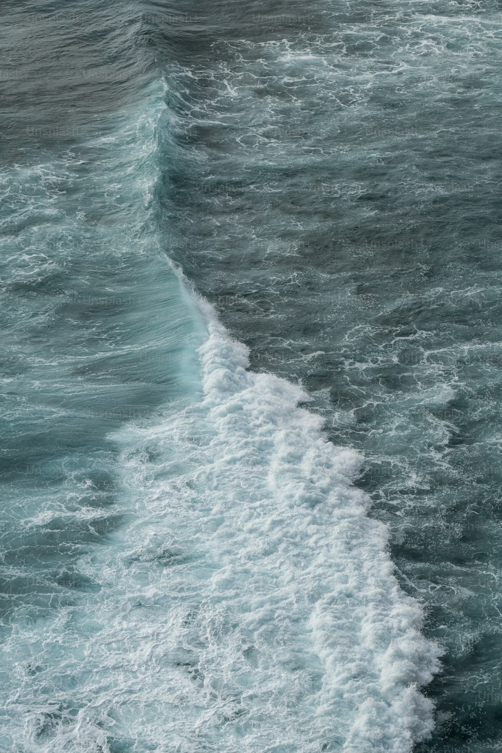 a man riding a surfboard on top of a wave in the ocean