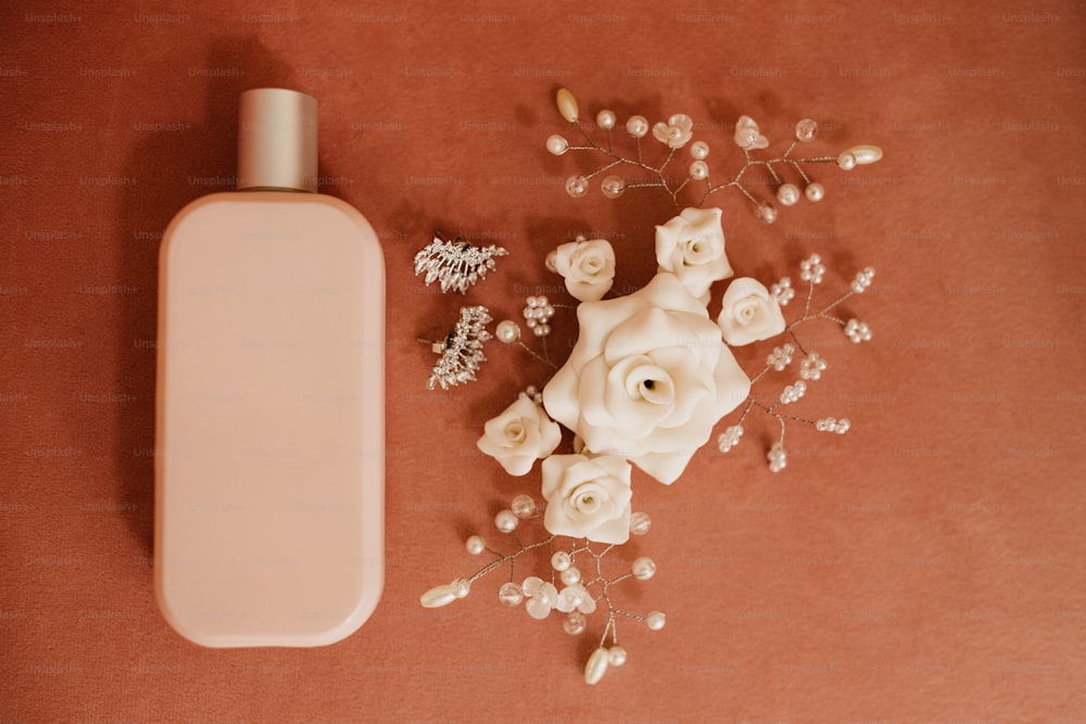 a bottle of lotion next to a bouquet of flowers