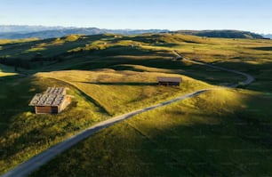 an aerial view of a grassy field with a road running through it