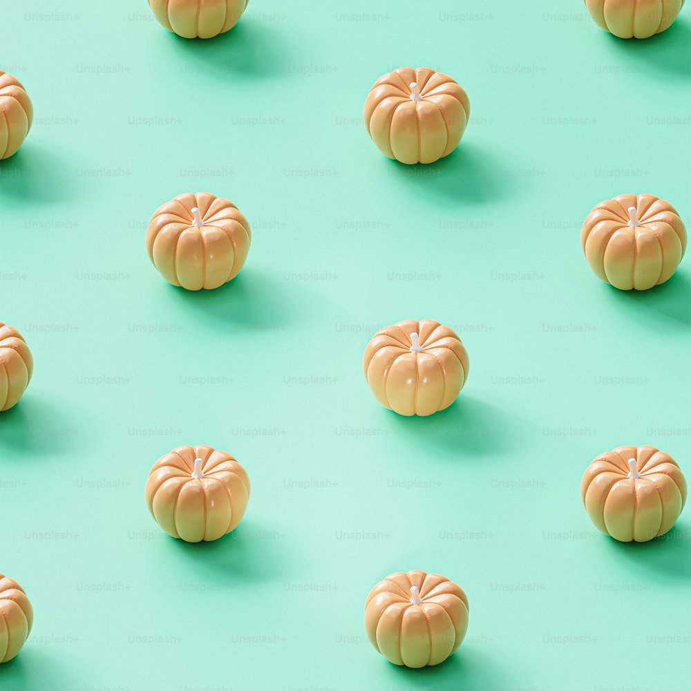 a group of small pumpkins sitting on top of a green surface