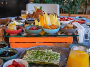 a table filled with plates of food and bowls of fruit