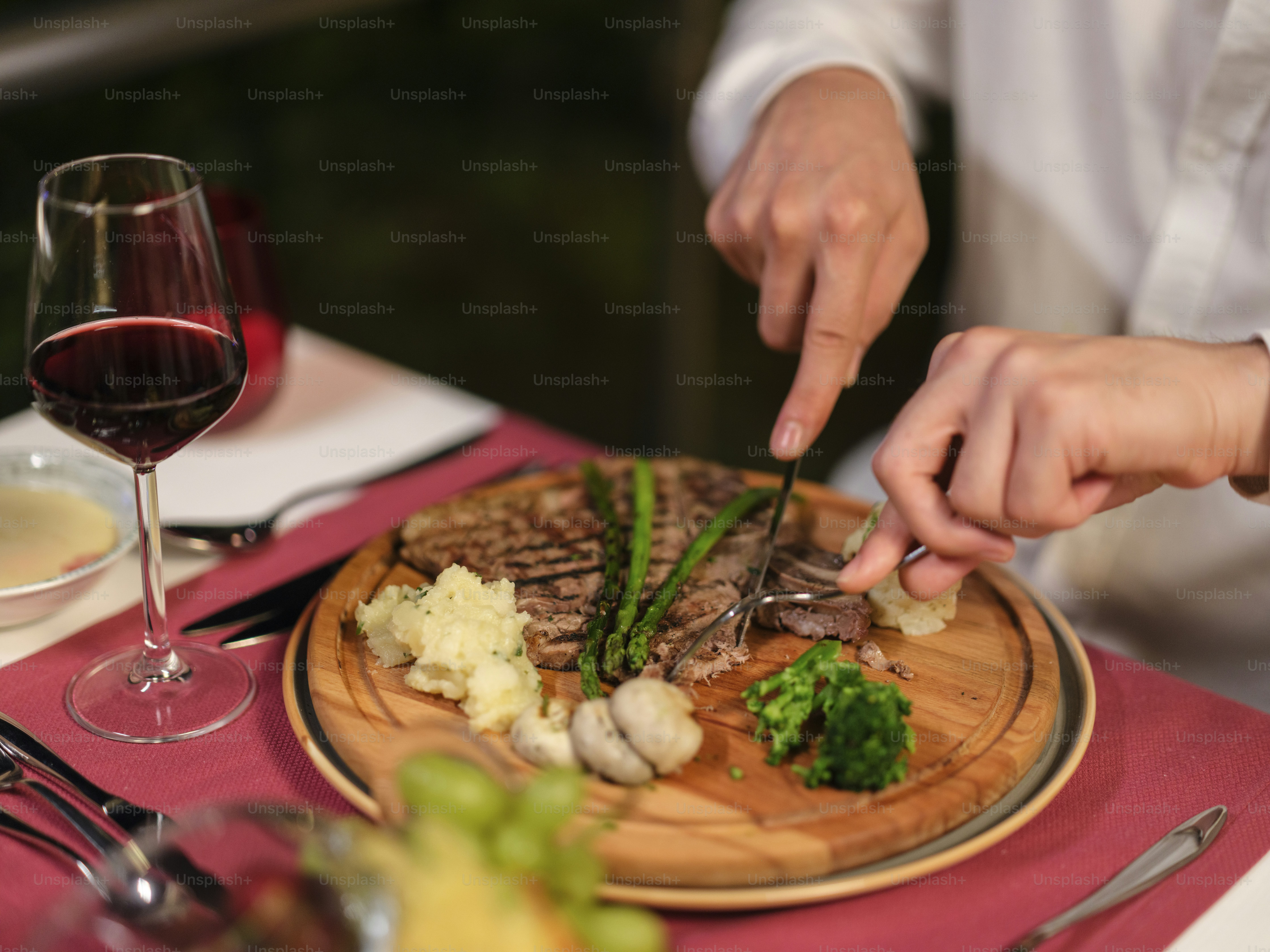 a person is cutting up some food on a plate