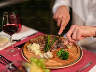 a person is cutting up some food on a plate