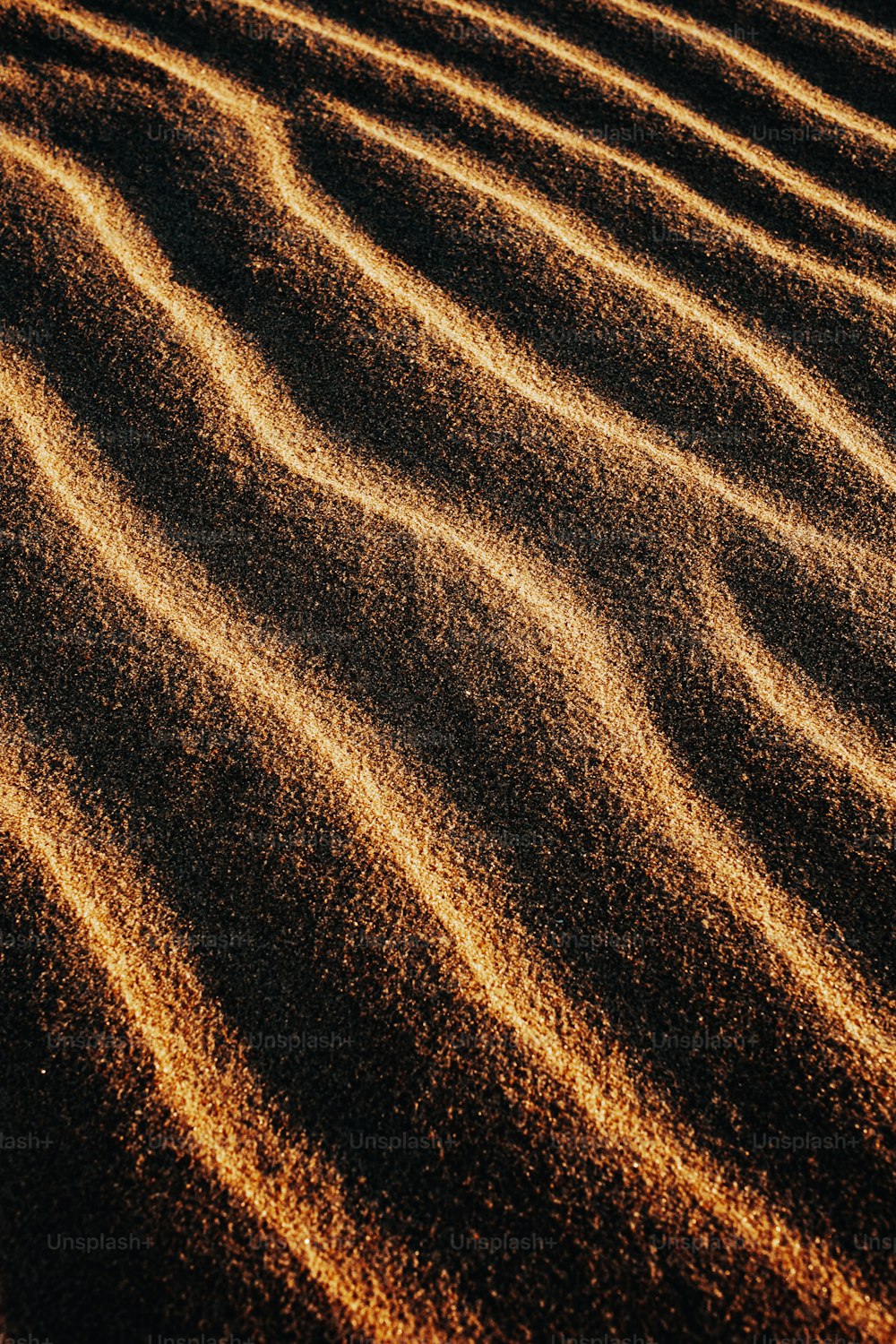 a sandy area with lines of sand in the sand
