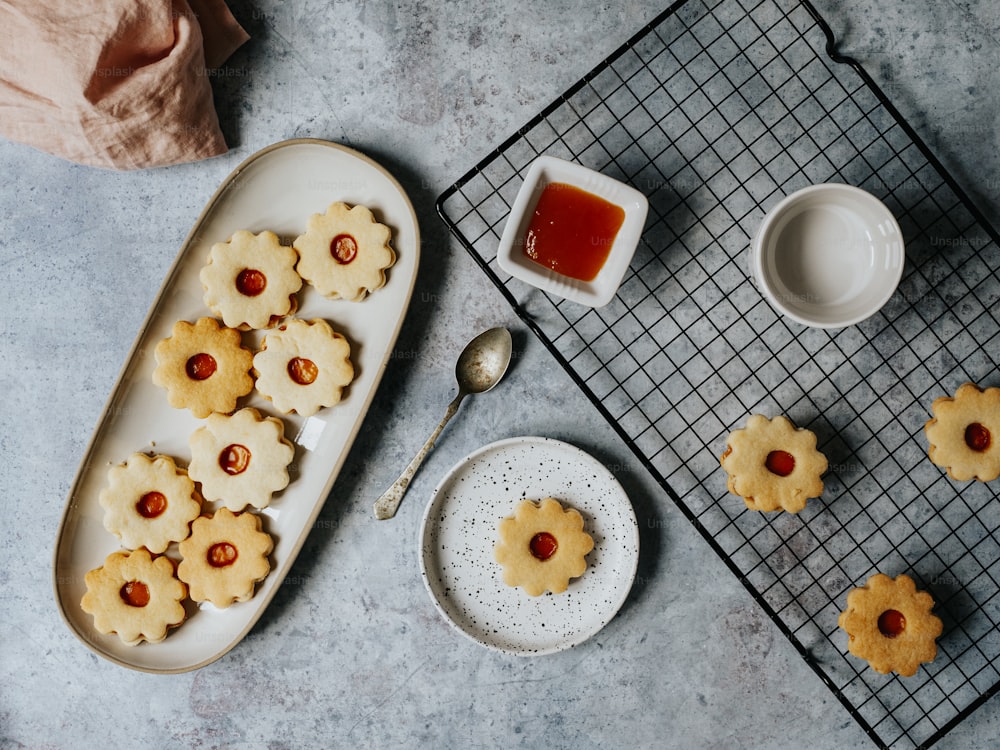 a tray of cookies and a bowl of ketchup on a cooling rack
