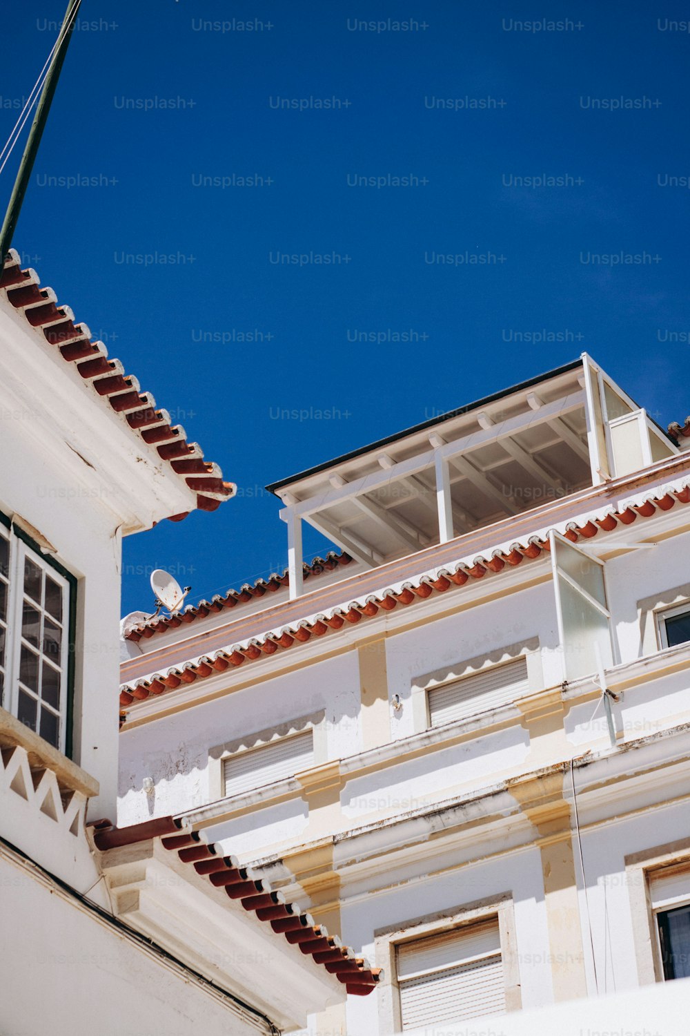 a bird is perched on the roof of a building