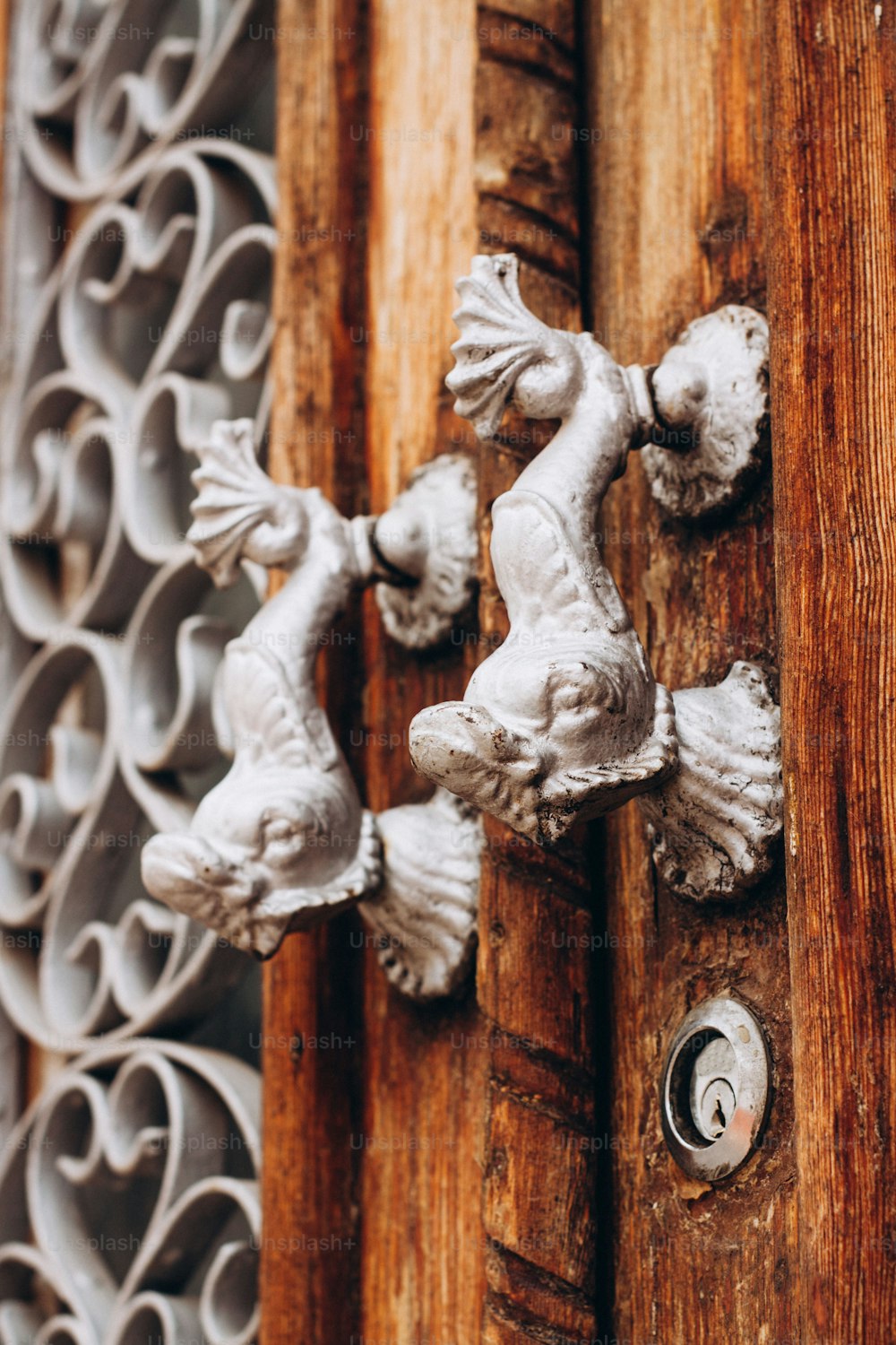 a close up of a door handle on a wooden door