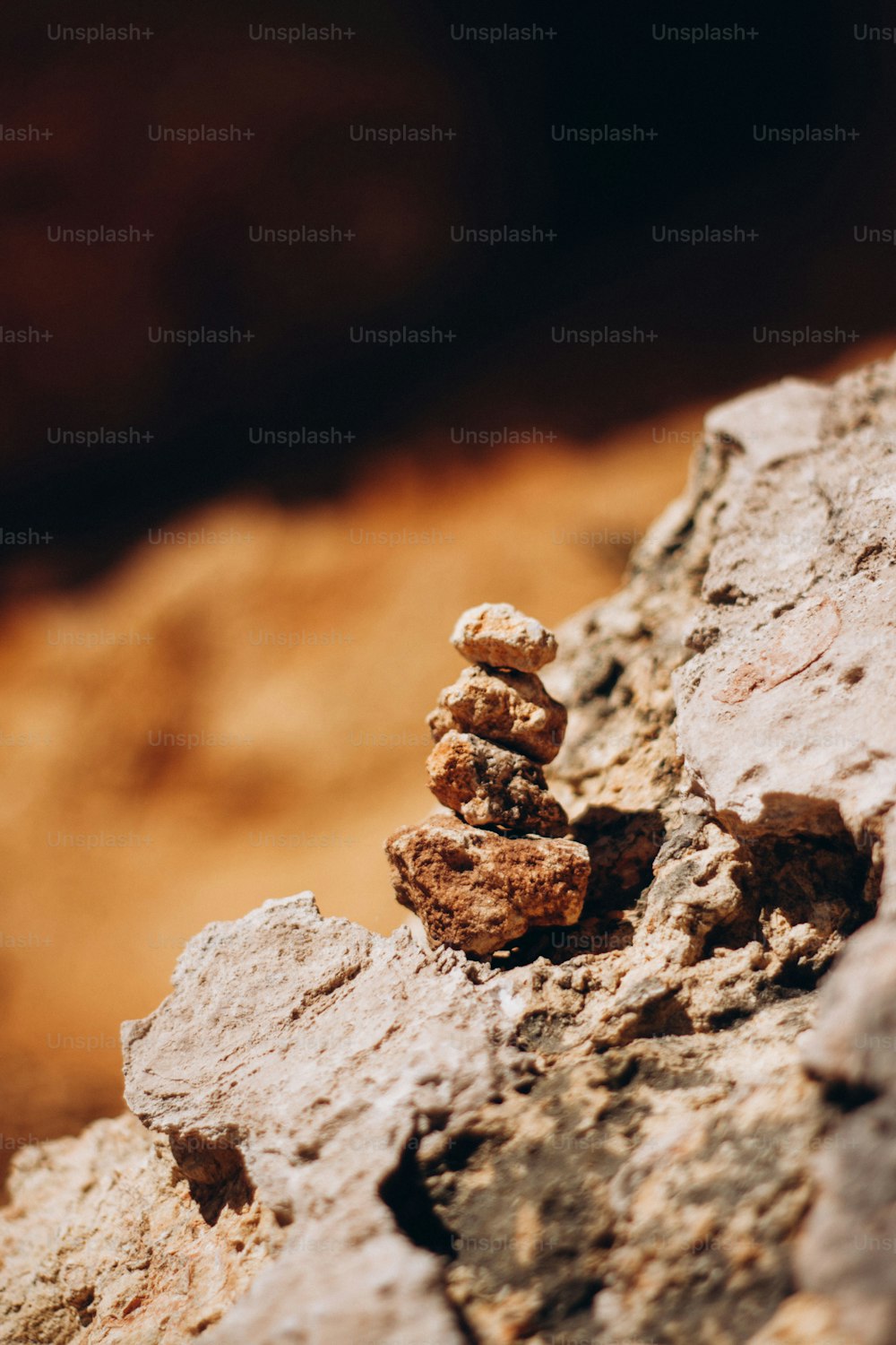 a pile of rocks sitting on top of a dirt field