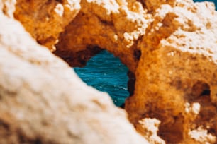 a view of a body of water through some rocks