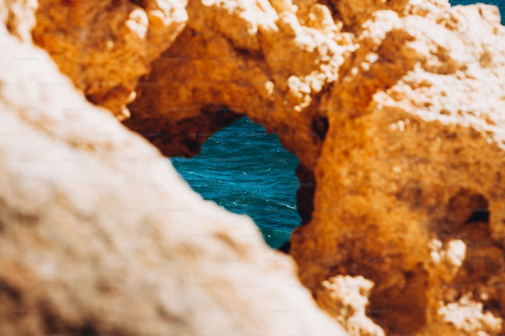 a view of a body of water through some rocks