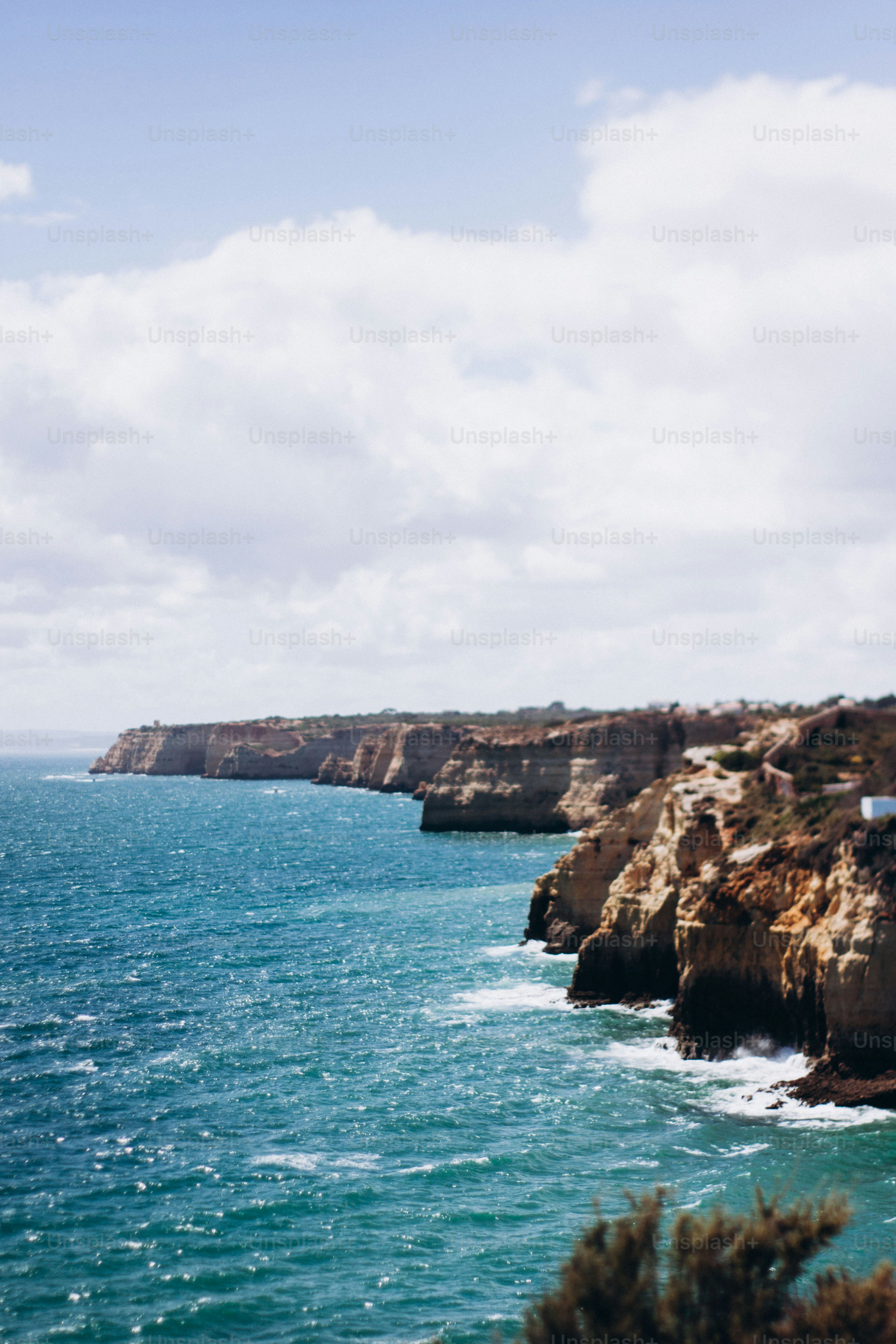 a large body of water next to a rocky cliff