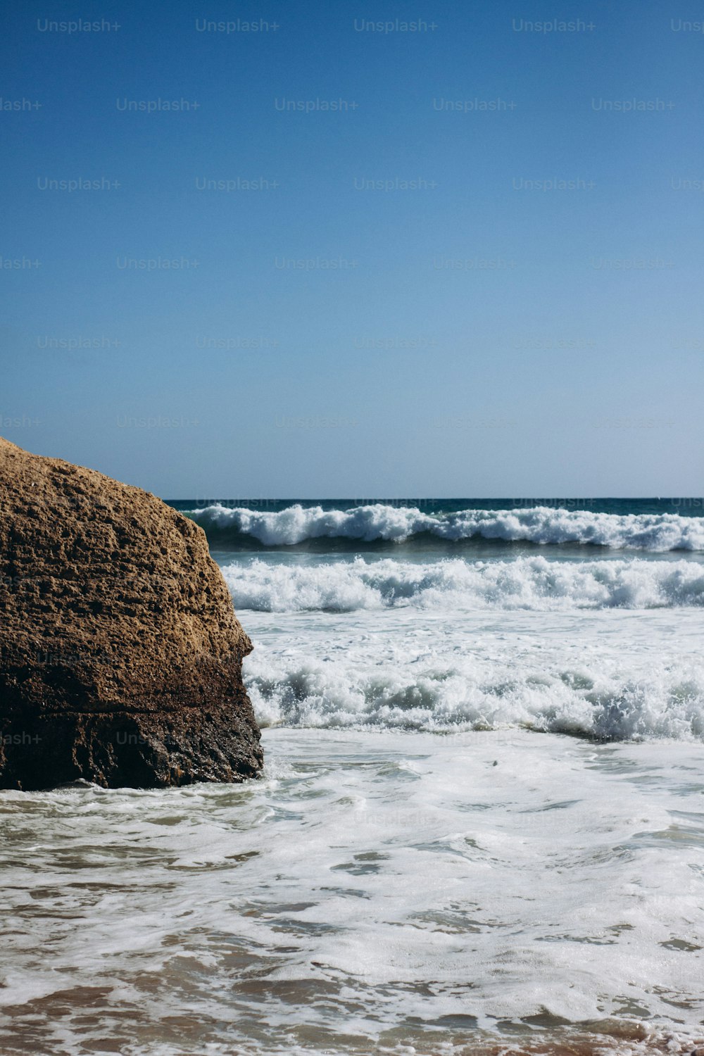 a large rock sticking out of the ocean