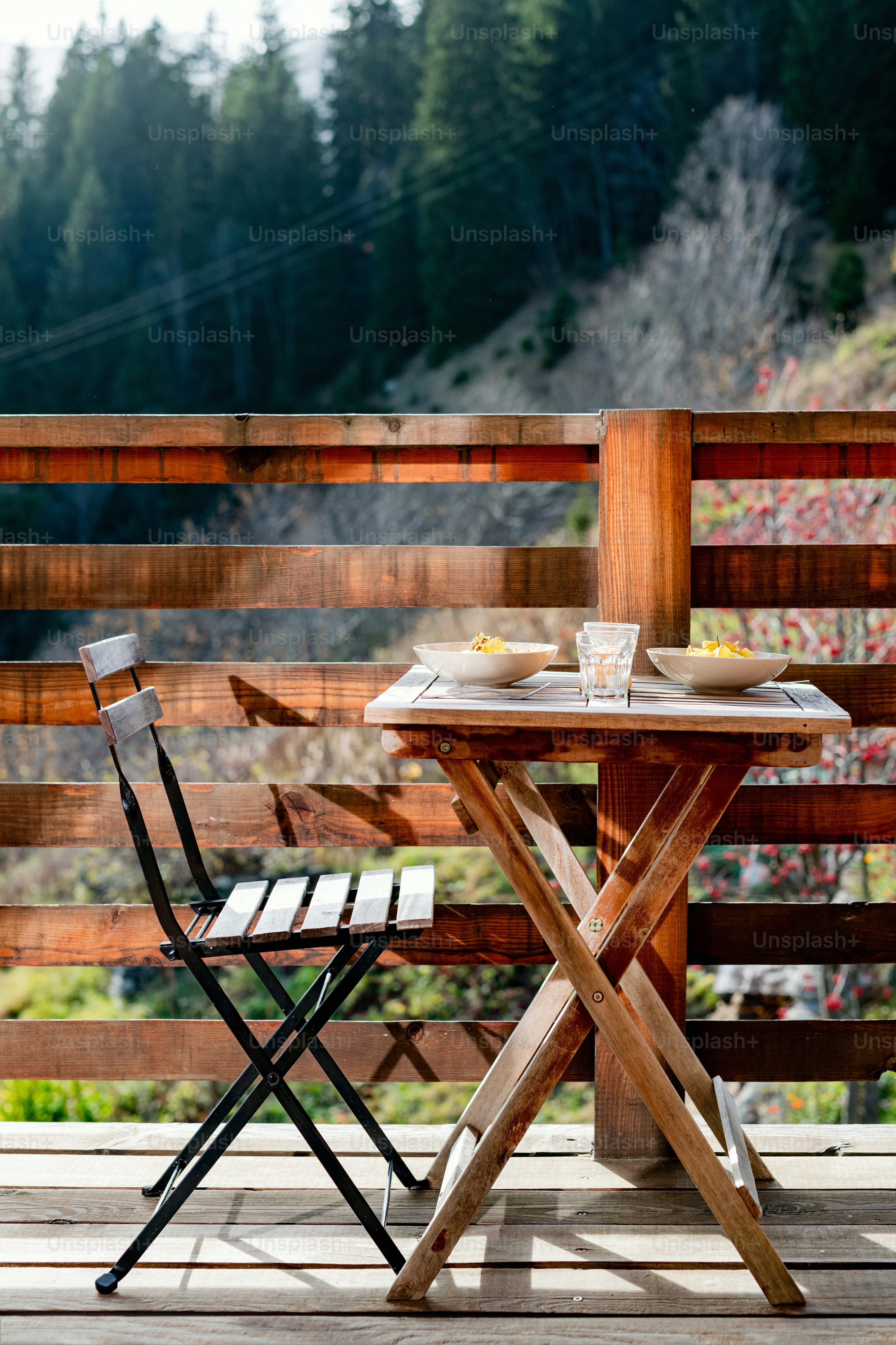 a couple of chairs sitting on top of a wooden table
