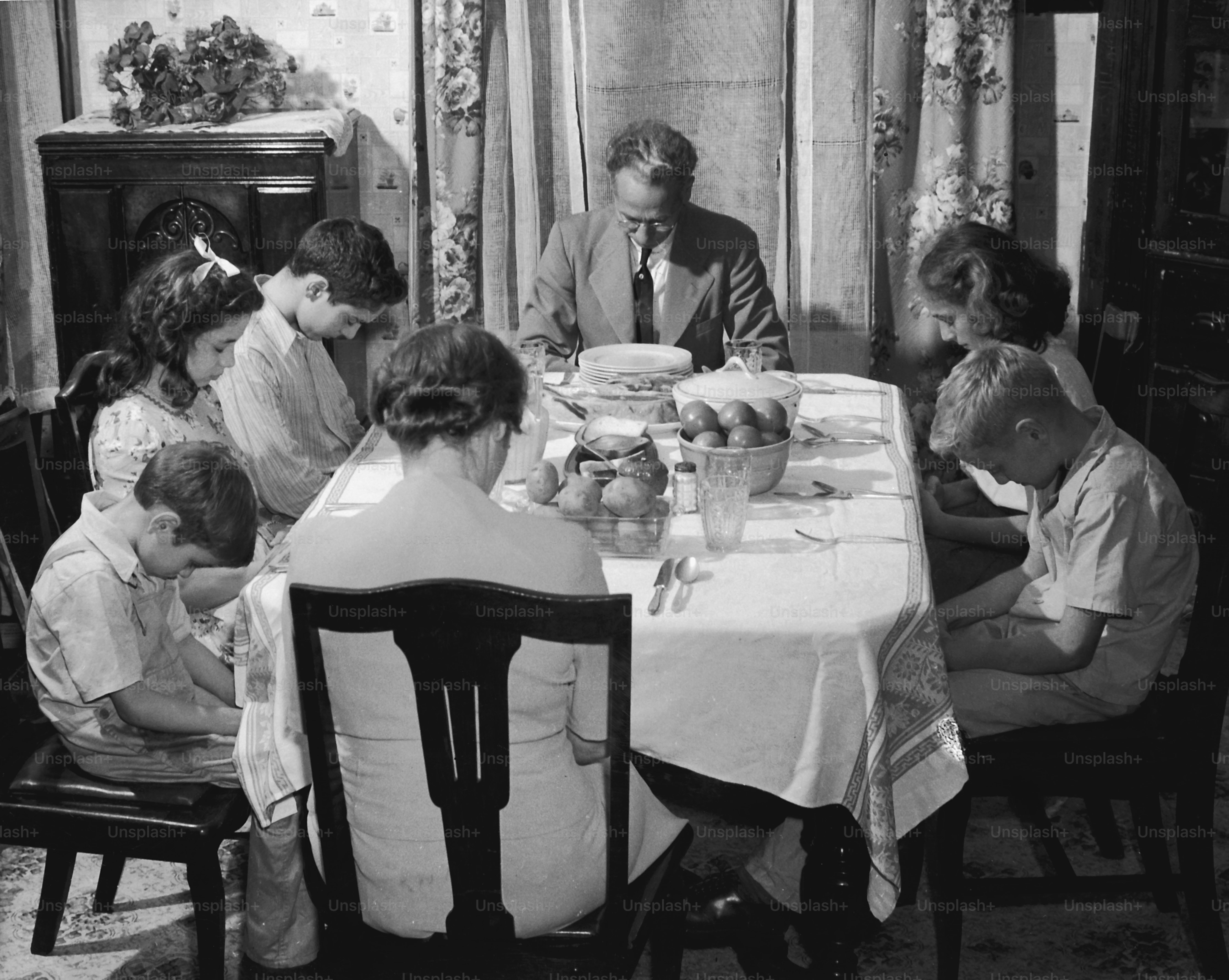 a group of people sitting around a table eating food