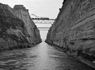 A train steams across one of the bridges that straddles the Corinth Canal in Greece.