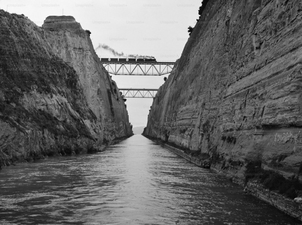 A train steams across one of the bridges that straddles the Corinth Canal in Greece.