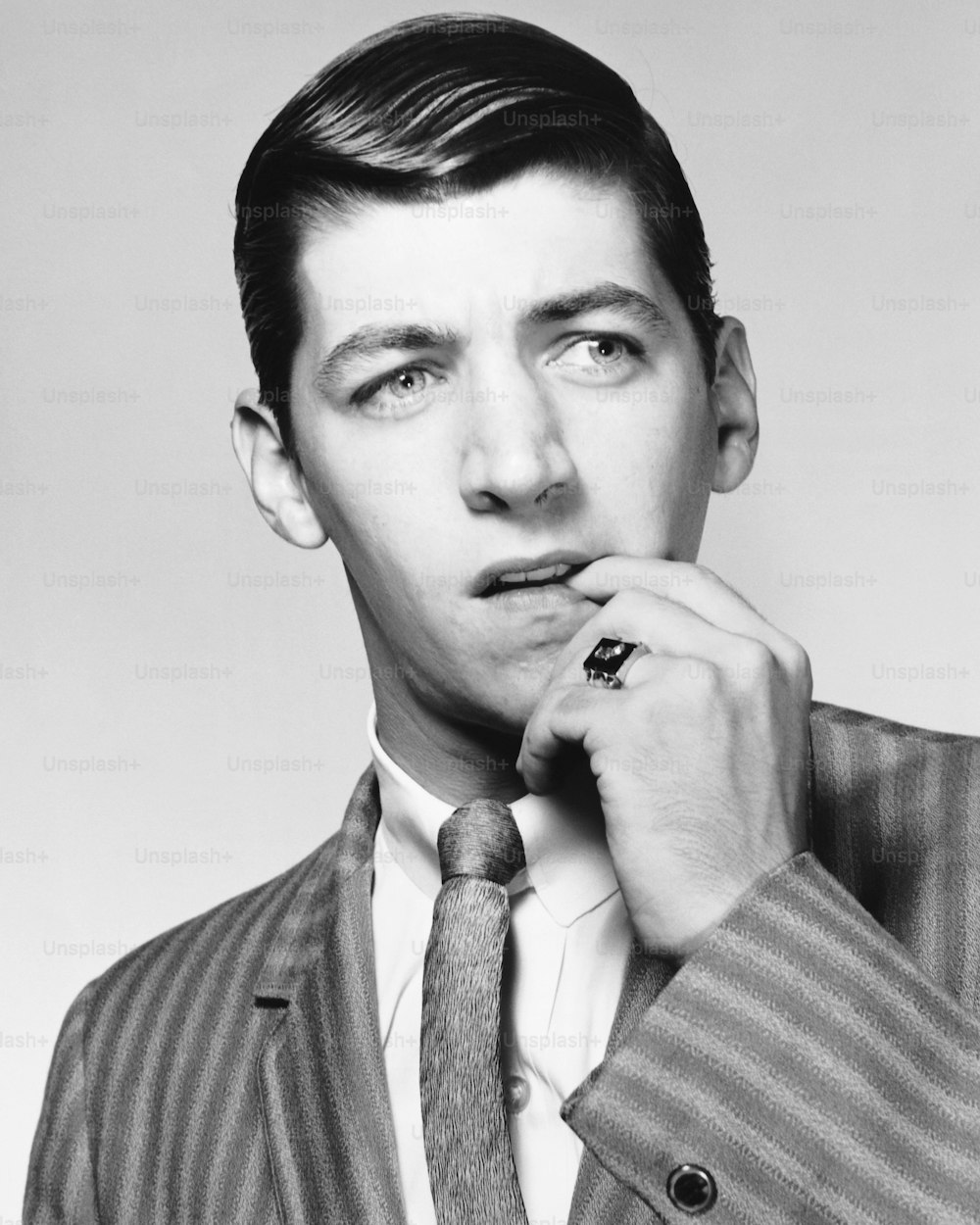 a black and white photo of a man in a suit