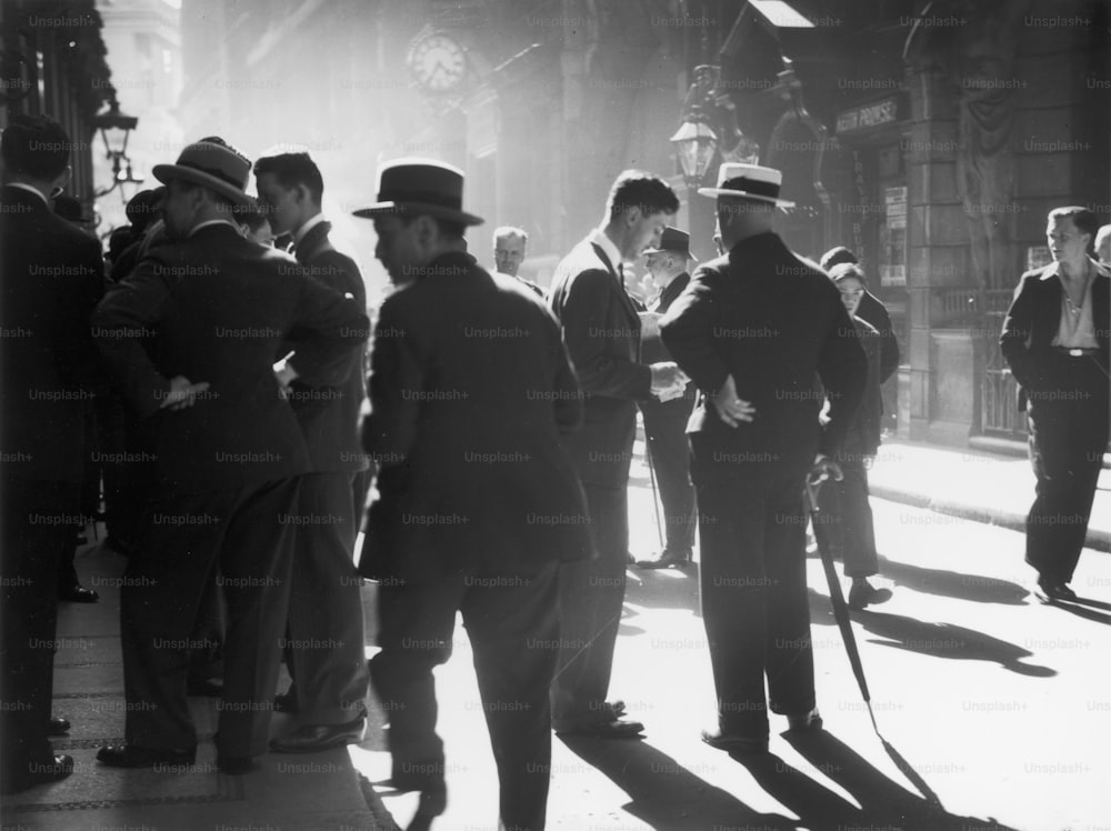 circa 1938:  City workers loitering in Throgmorton Street in the financial district of London.  (Photo by Chaloner Woods/Getty Images)