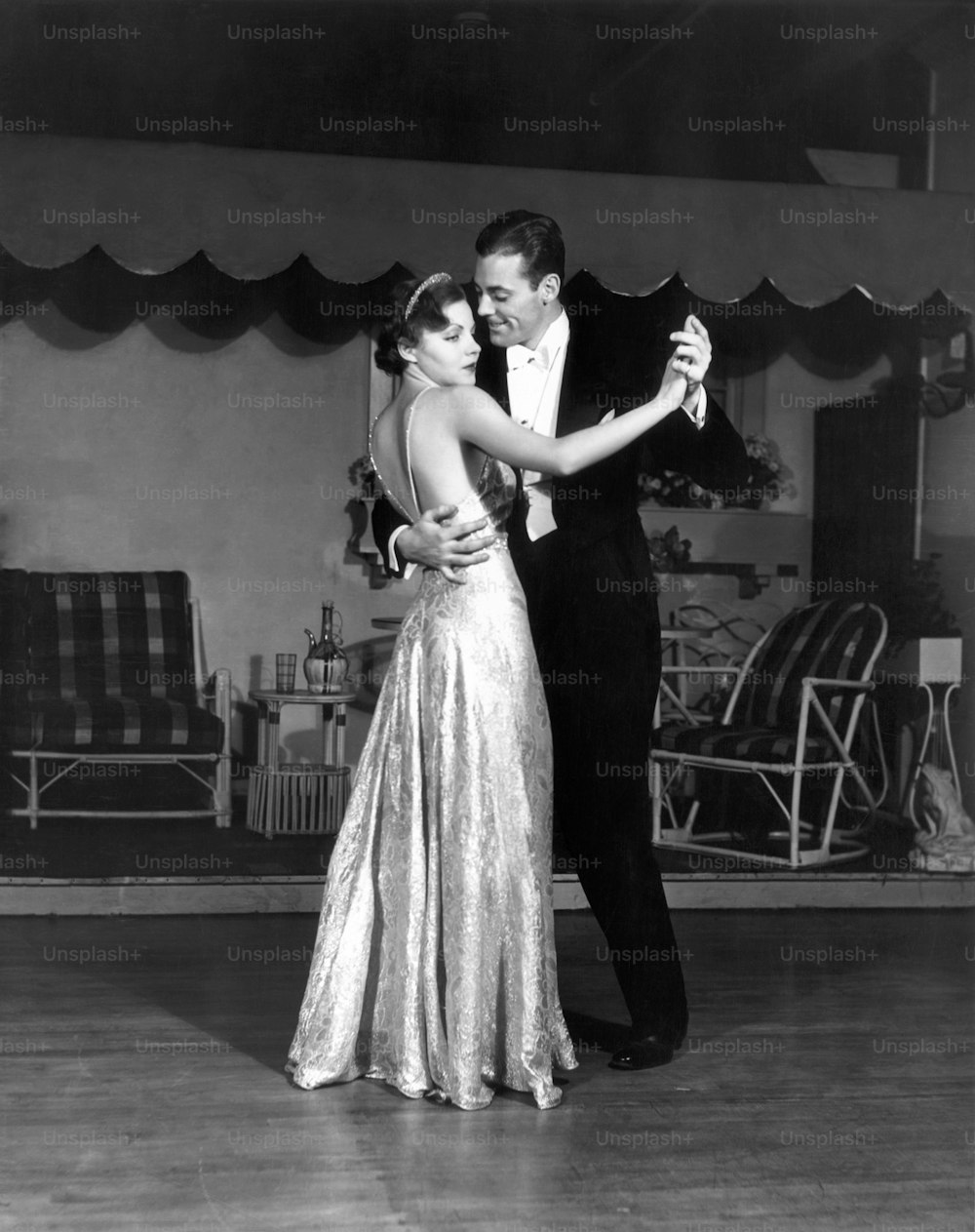 UNITED STATES - CIRCA 1950s:  Couple in formal wear dancing.