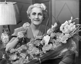 UNITED STATES - CIRCA 1950s:  Woman receiving flowers.
