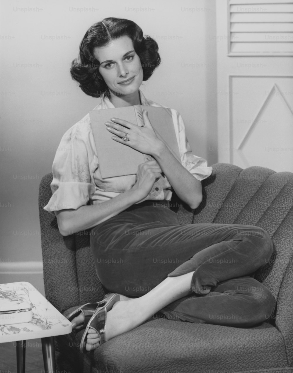 Woman Holding Book On Chest Sitting On Shell Chair. (Photo by George Marks/Retrofile RF/Getty Images)