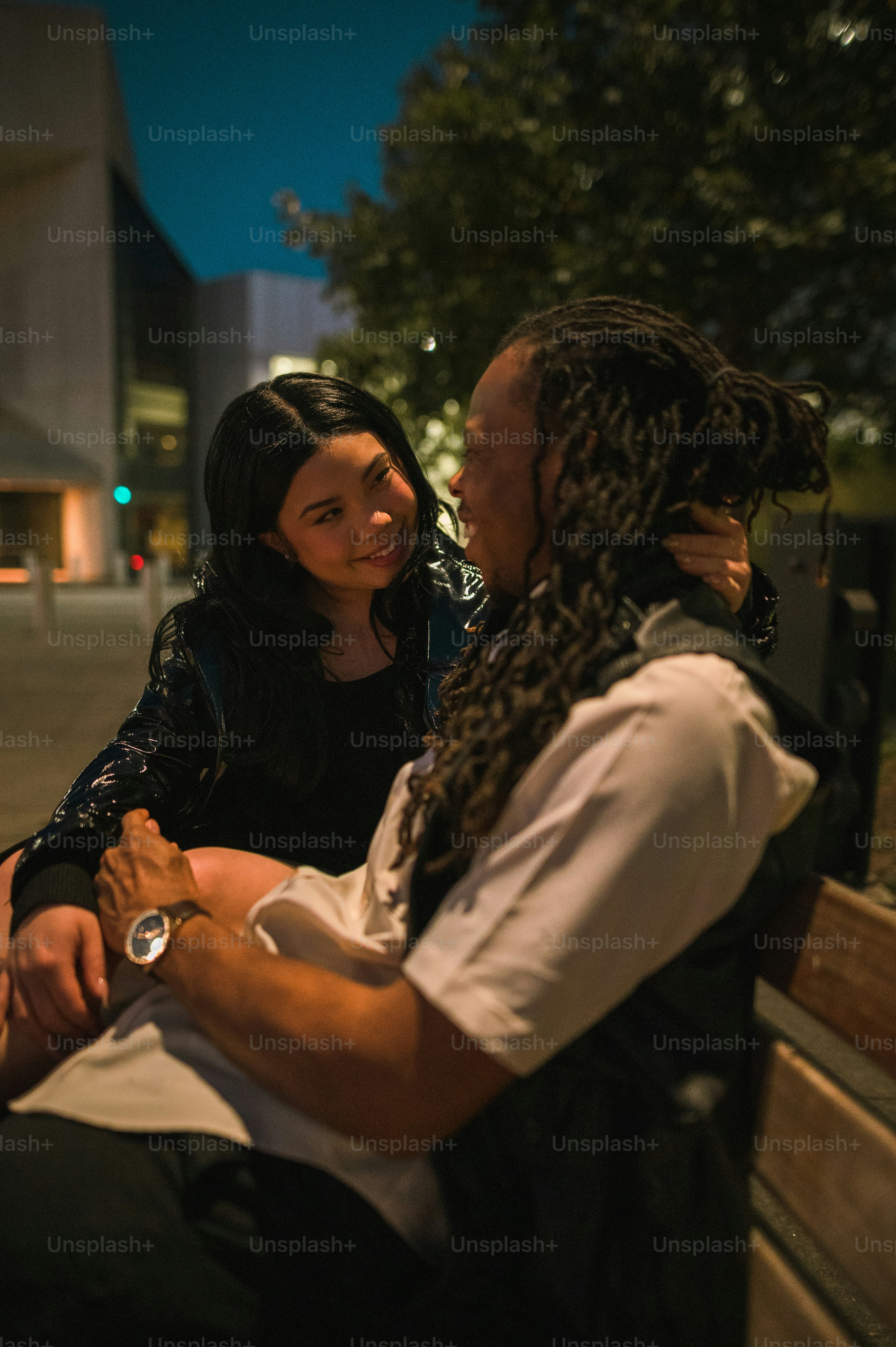 a man and a woman sitting on a bench