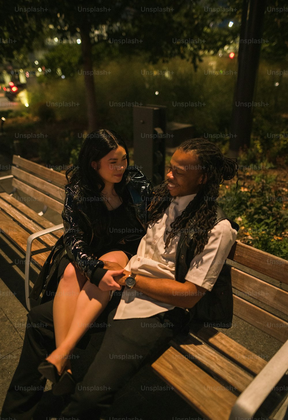 a man and a woman sitting on a bench