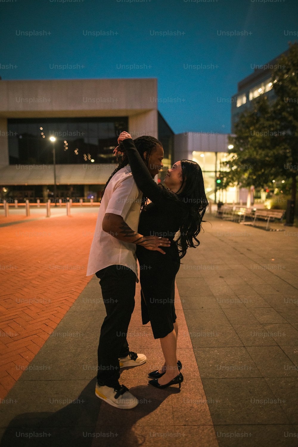 a man and a woman kissing on a skateboard