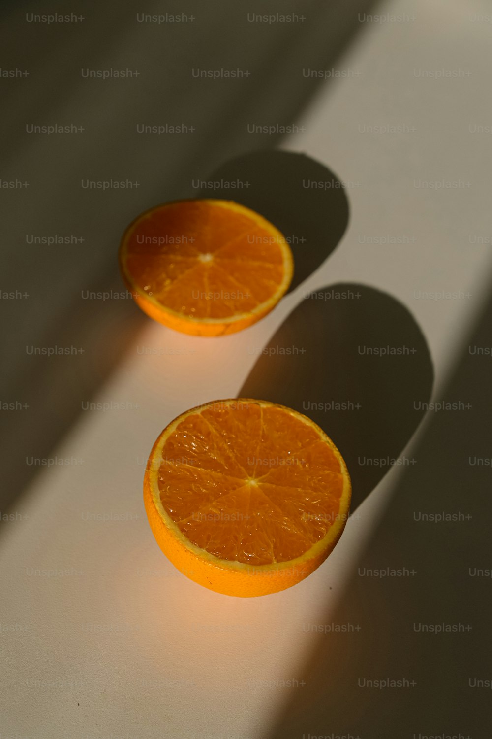 two halves of an orange sitting on a table