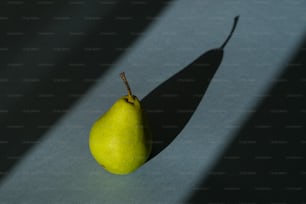 una pera gialla seduta sopra un tavolo