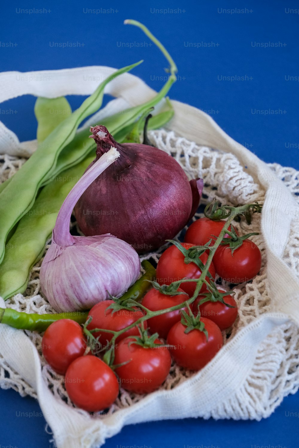 a bunch of vegetables sitting on top of a cloth