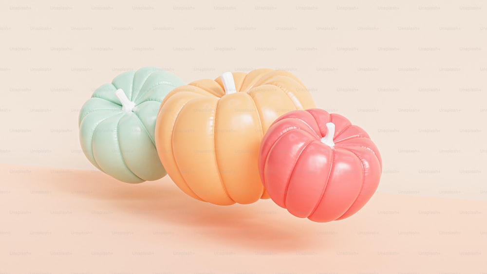 a group of three pumpkins sitting on top of a table