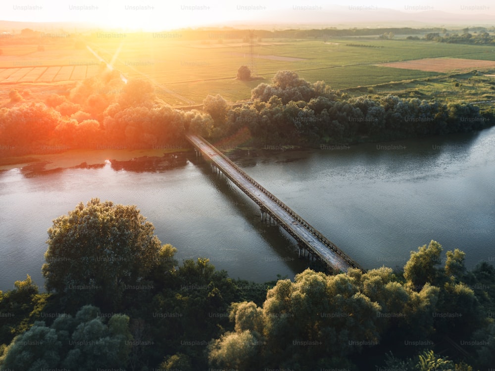 a train traveling over a bridge over a river