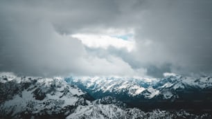 a view of the top of a mountain range under a cloudy sky
