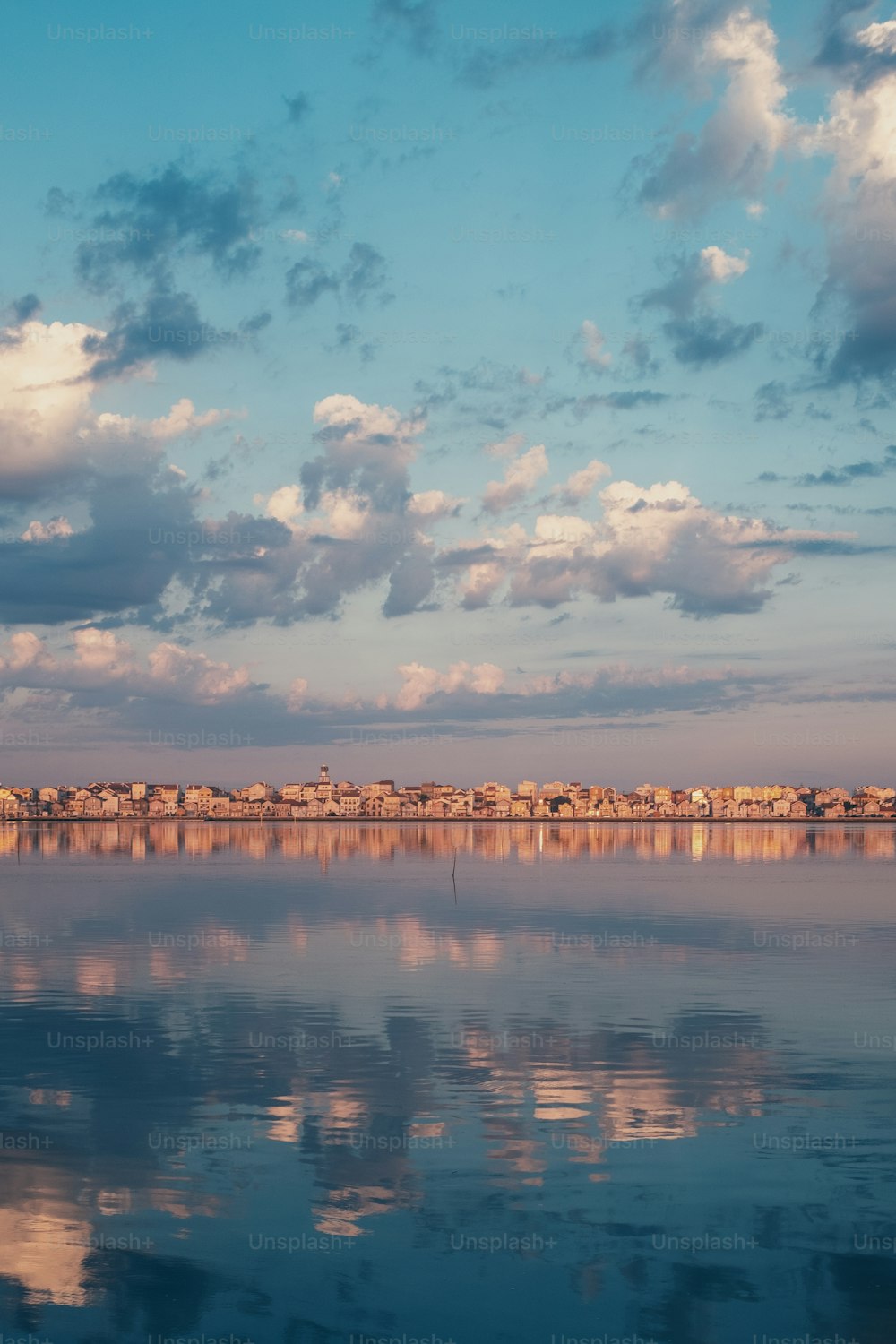 a large body of water with a sky in the background