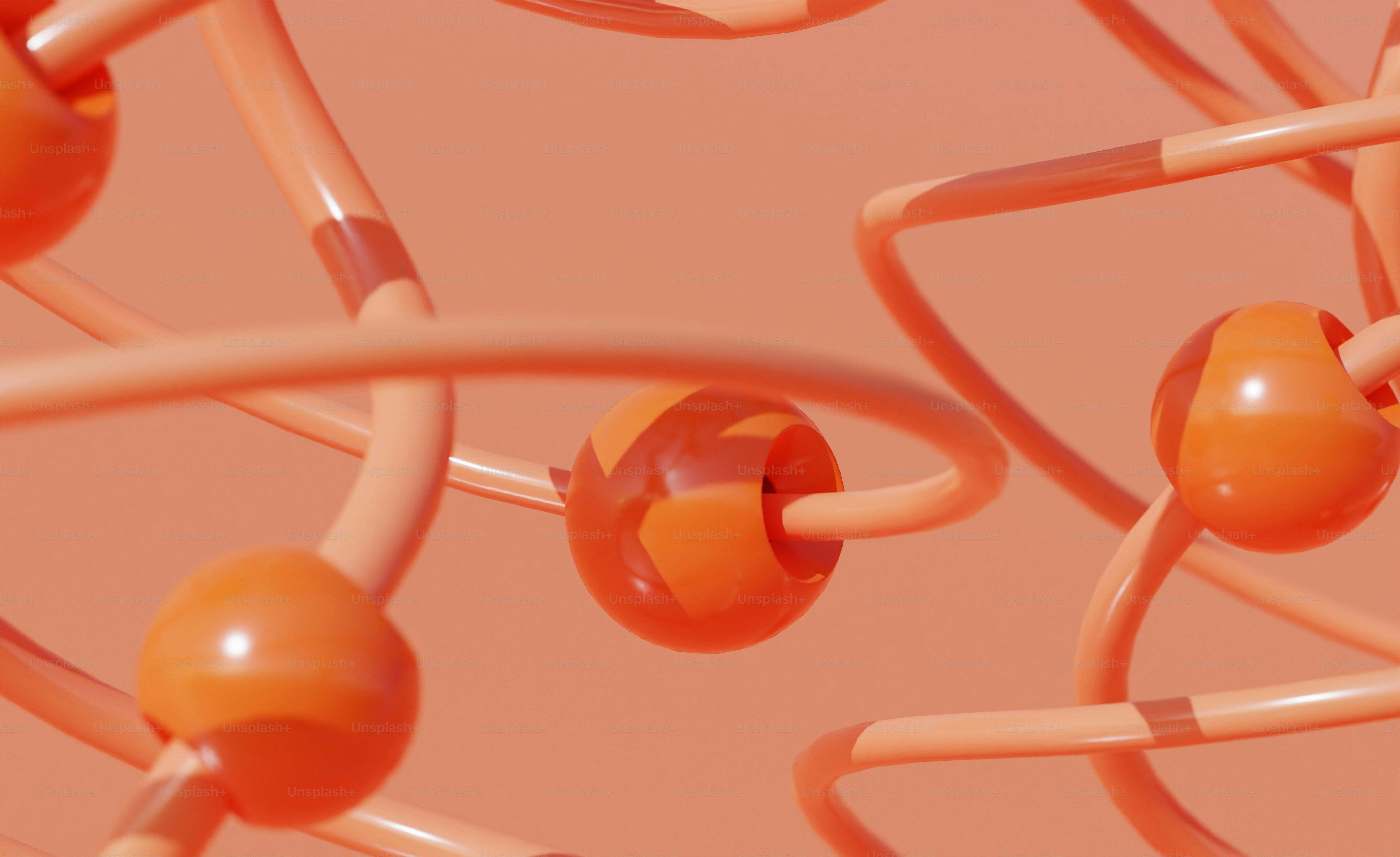 ein Haufen orangefarbener Bälle und Drähte auf rosa Hintergrund